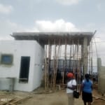 A fenced and gated plot of land in a serene environment.